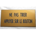 plaque adhésive "NE PAS TIRER APPUYER SUR LE BOUTON" dorée