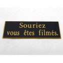 plaque adhésive "souriez vous êtes filmés" noire et or